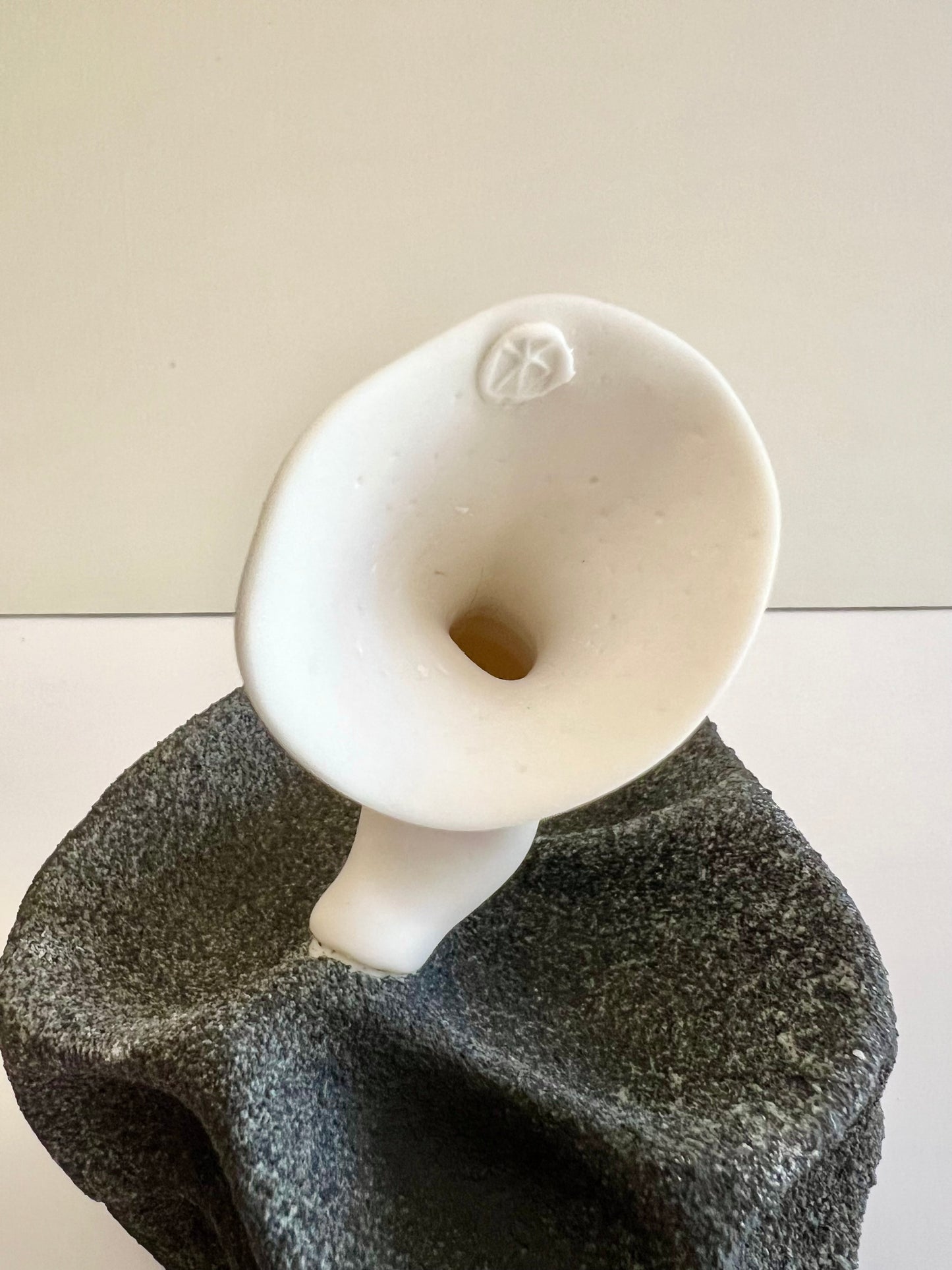 Artist's stamp on the white porcelain stem of Crazy Wallflower — Black Spore.