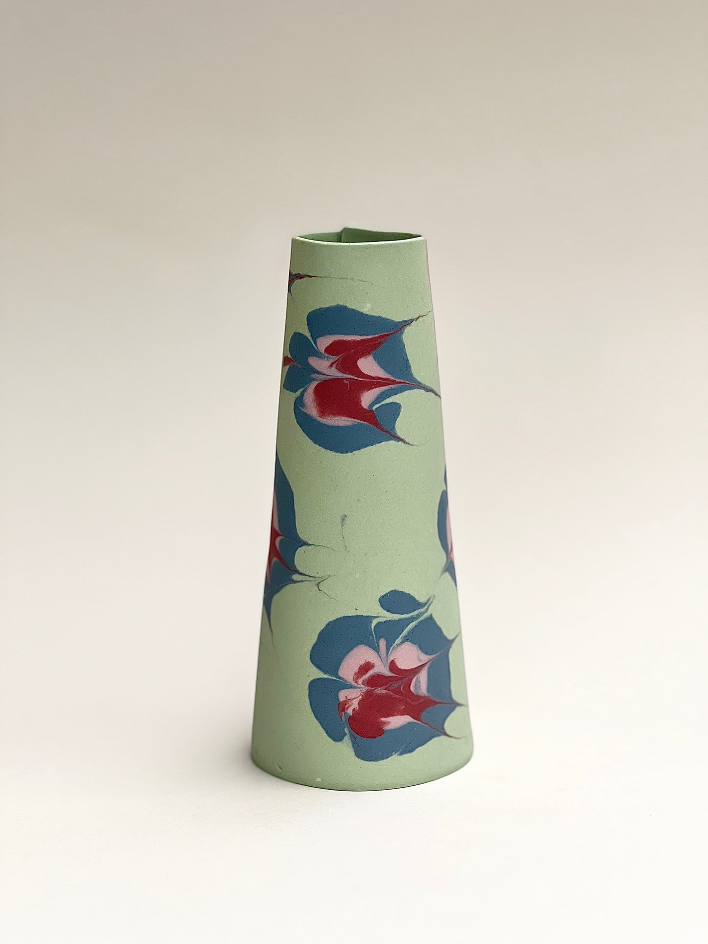 Conical vases - splash colors red, pink and blue on green background