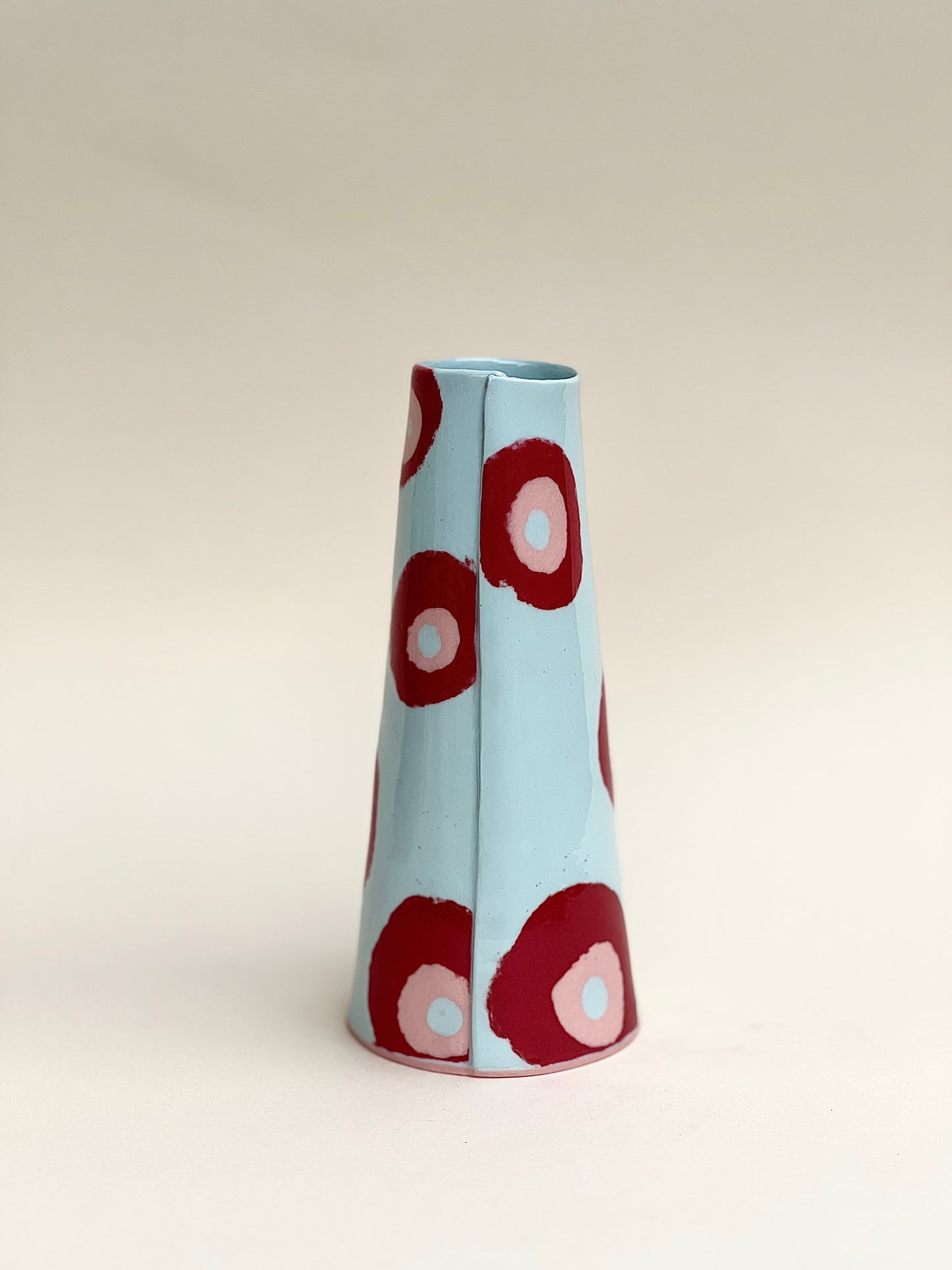 Conical vase - colored circles red pink on pale blue background