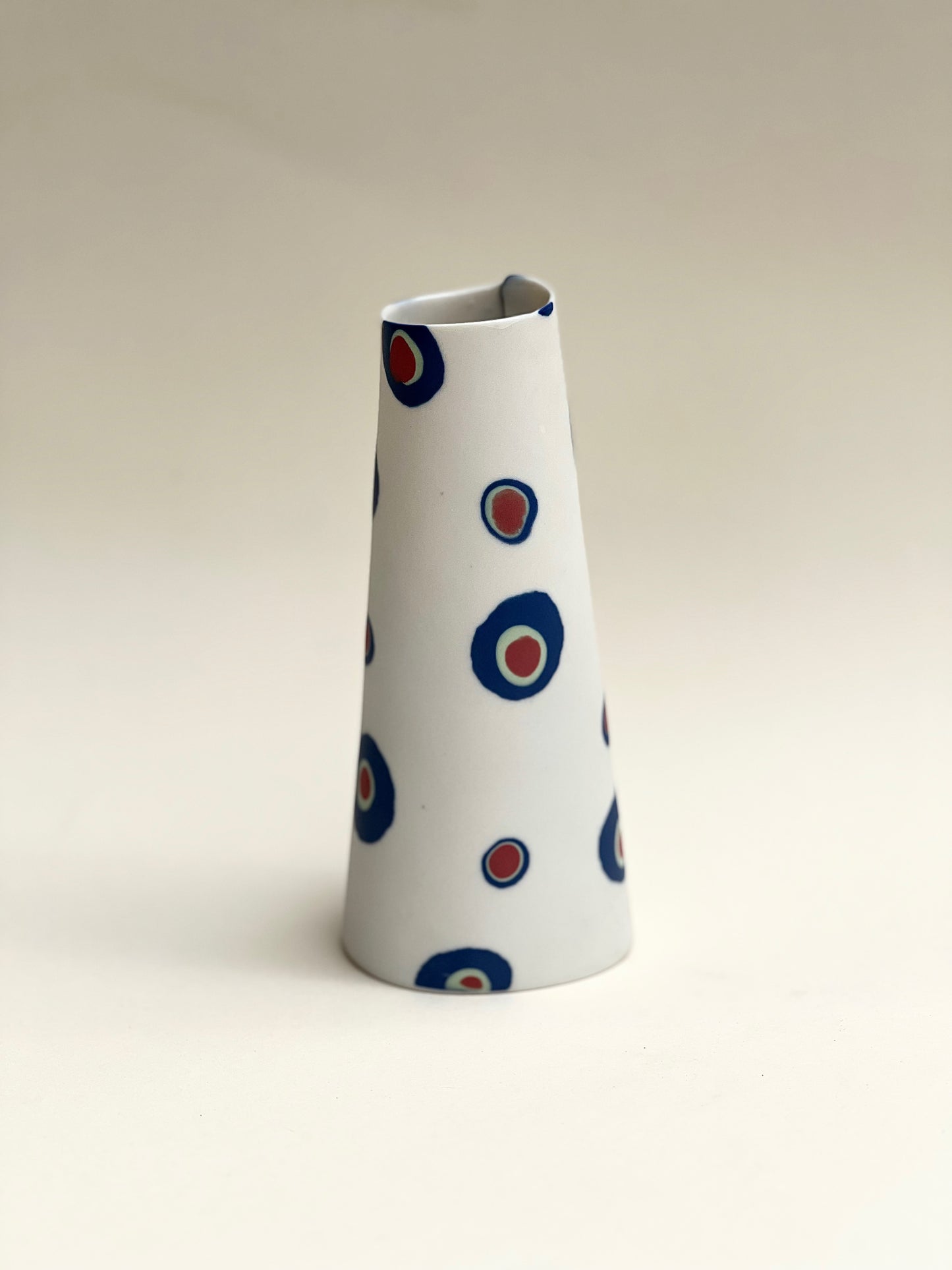 Conical vase - colored circles blurred,pale green on white background