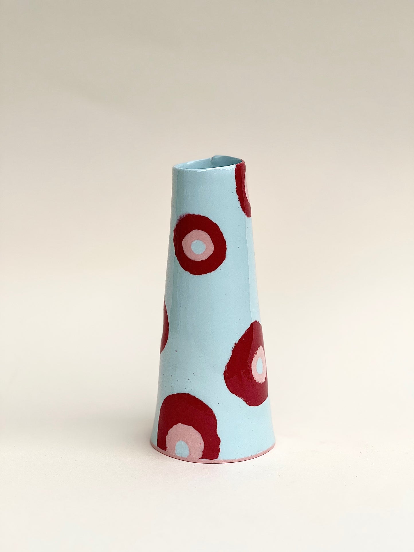 Conical vase - colored circles red pink on pale blue background