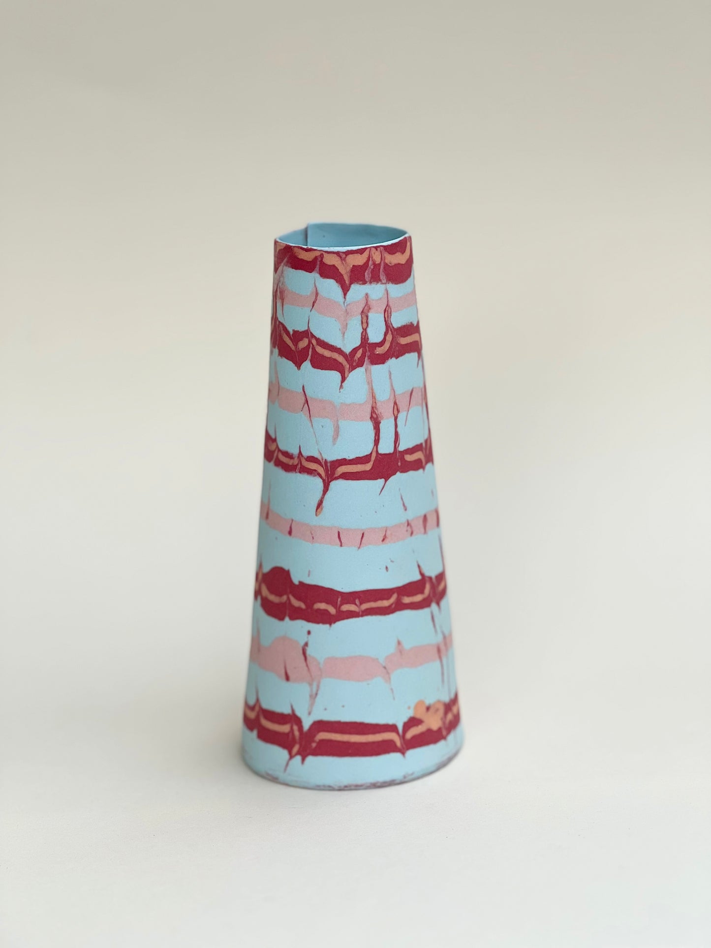 Conical vases - red and pink on pale blue background