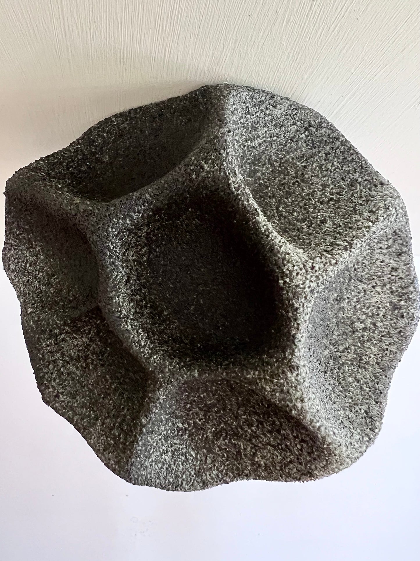 Close-up of the rough black and white porcelain surface of Crazy Wallflower — Black Spore, with subtle grey variations and sculpted recesses.