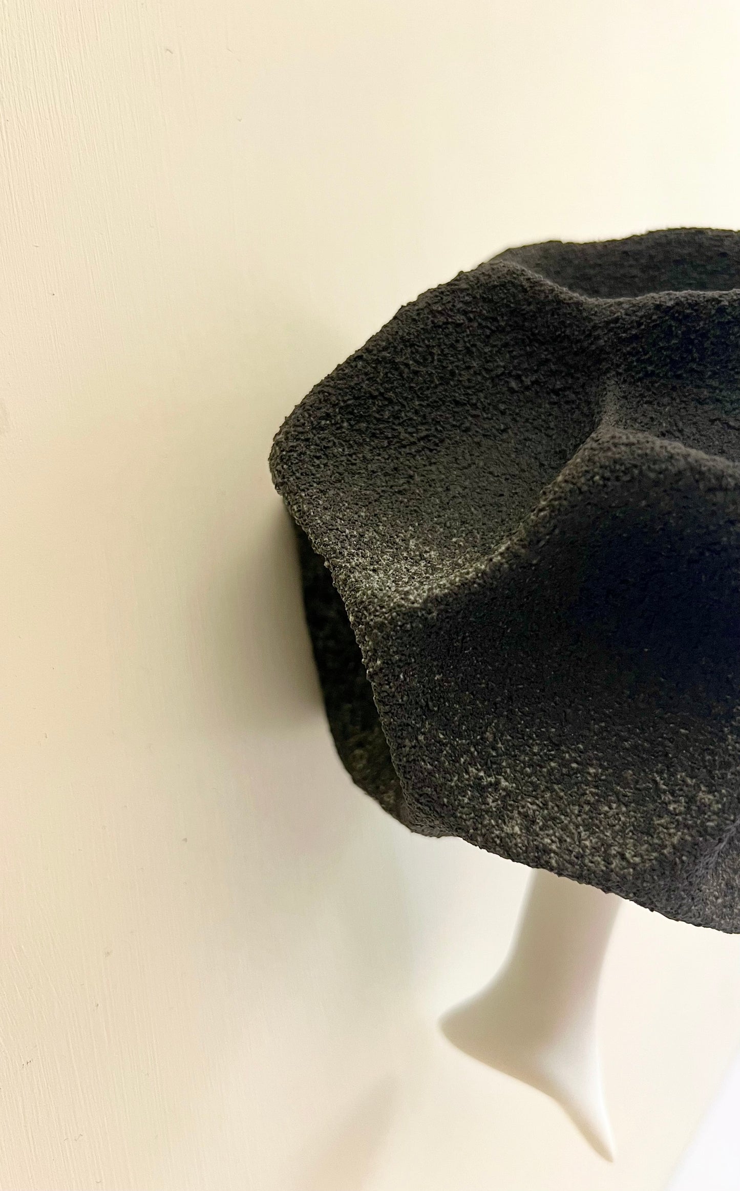 Side view showing the rear mounting detail and how the sculpture sits against the wall when installed.