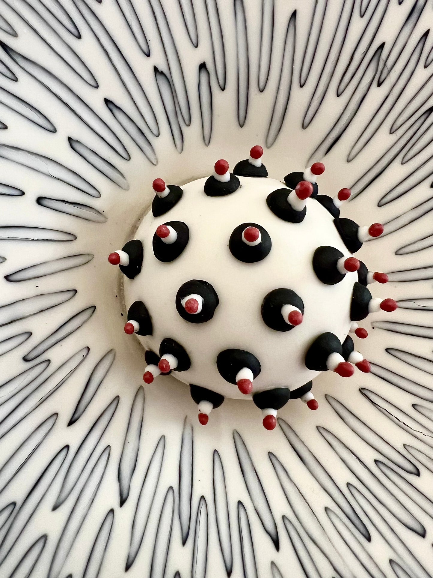 Close-up of the centre of Crazy Wallflower — Pollen, showing black, white and red porcelain details
