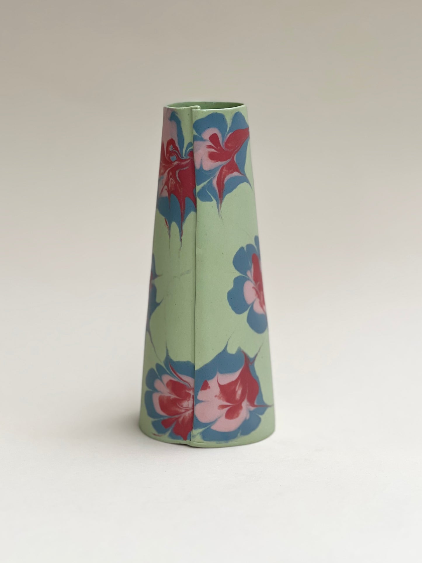 Conical vases - splash colors  red, pink and blue on green background