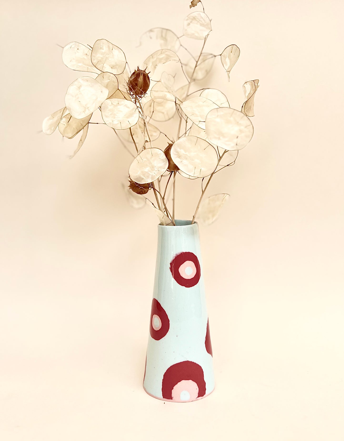 Conical vase - colored circles red pink on pale blue background