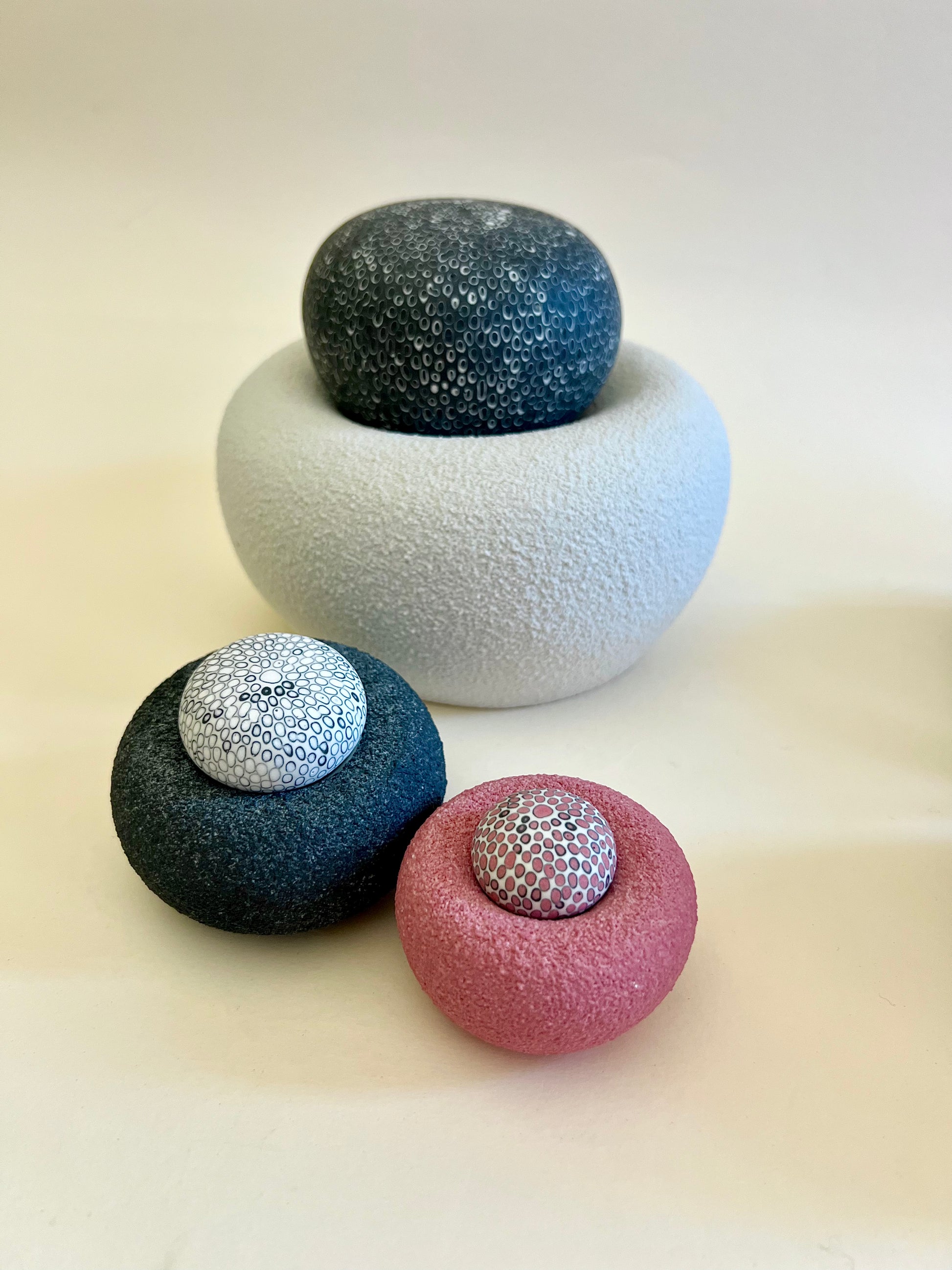 Close-up of hand-carved black and white porcelain inlay decorating the sculptural sphere.