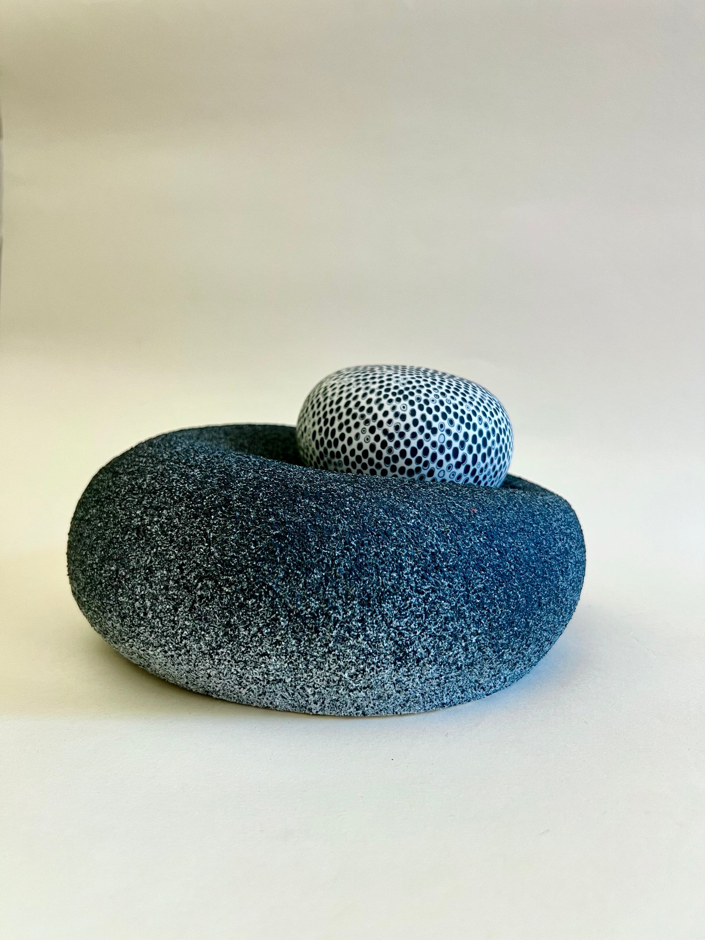 Side view of porcelain sculpture showing the soft cushion-like form of the textured base.
