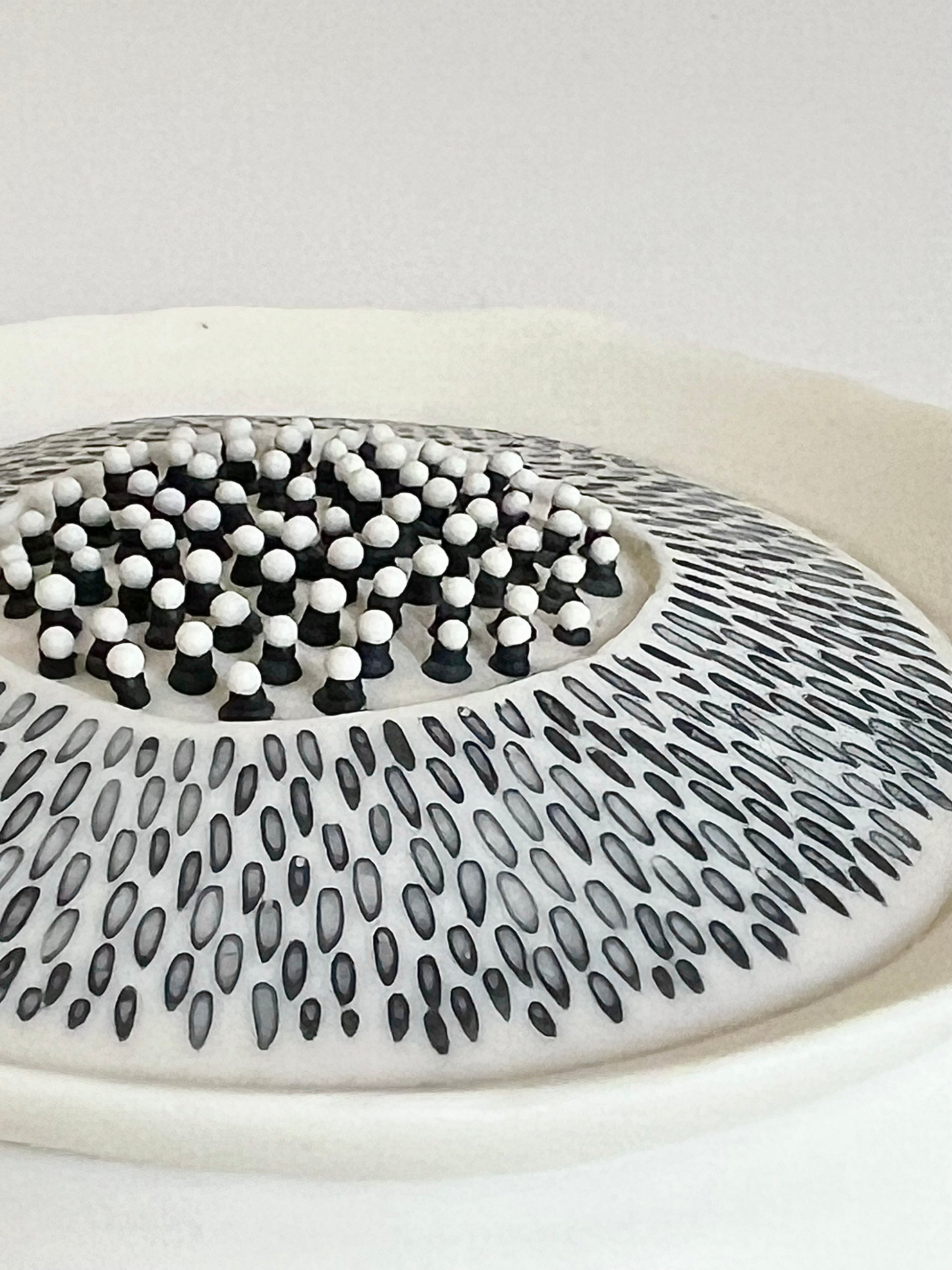 Close-up of the central detail on Pulse 1, with raised black and white porcelain drops