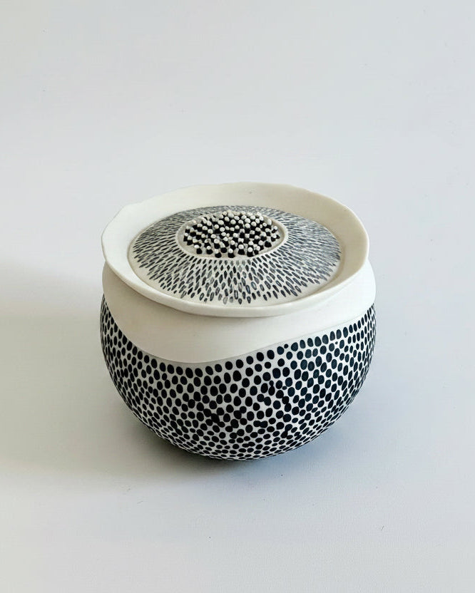 Pulse 1 handmade porcelain sculpture, front three-quarter view, with black porcelain inlay and black and white textured details