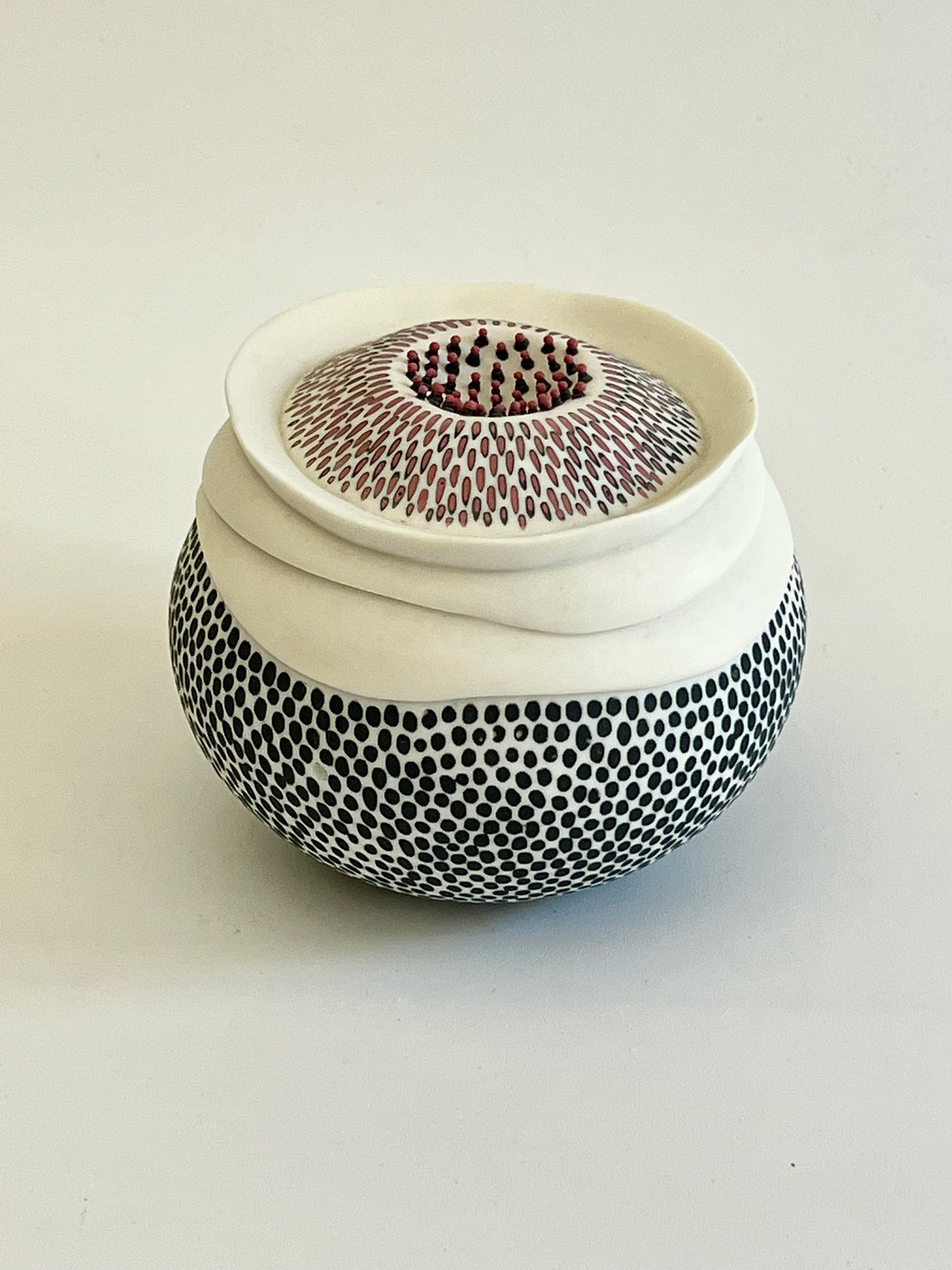 Pulse 2 handmade porcelain sculpture, side three-quarter view showing the organic rounded form and hand-inlaid surface