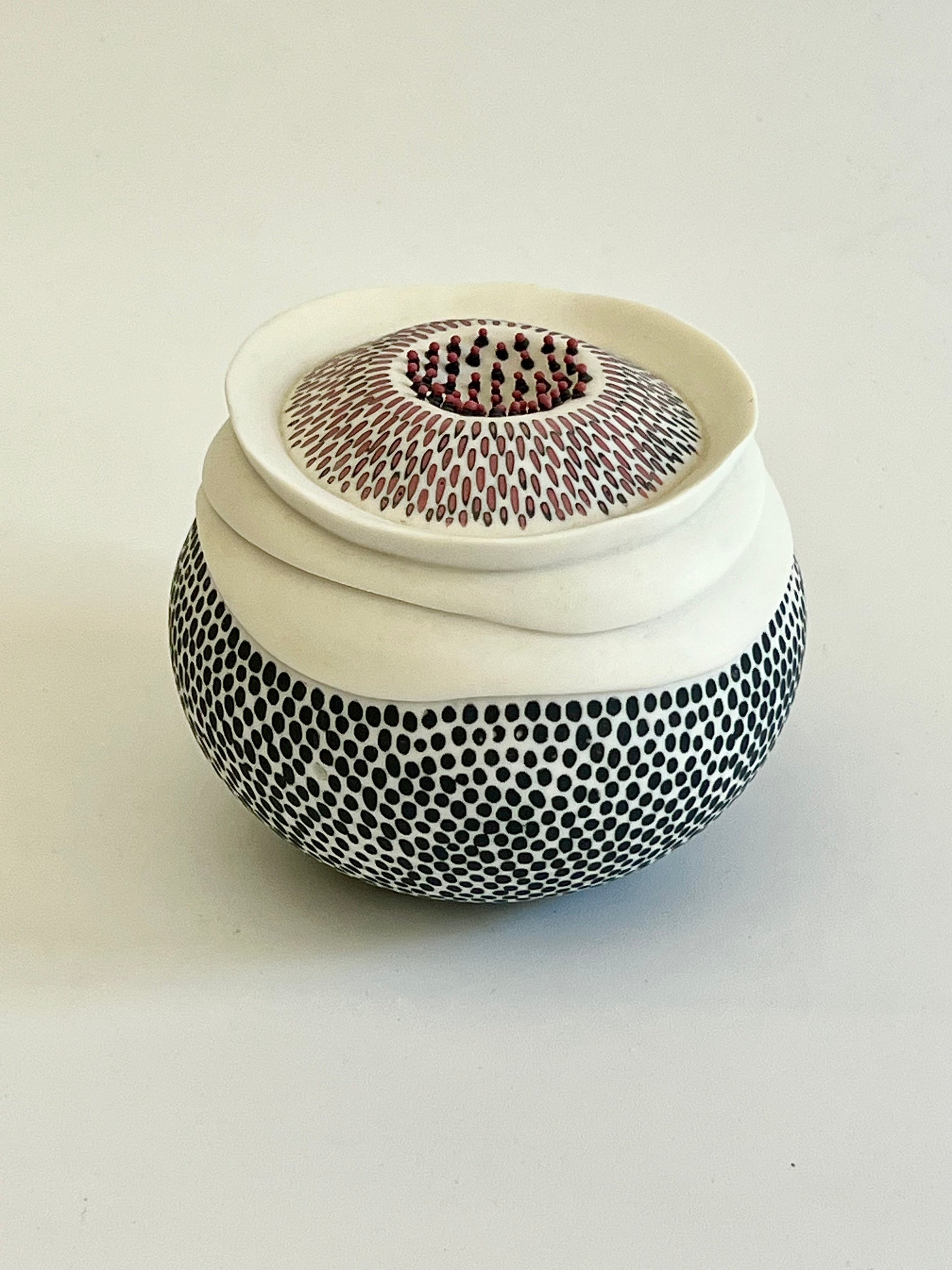 Pulse 2 handmade porcelain sculpture, side three-quarter view showing the organic rounded form and hand-inlaid surface