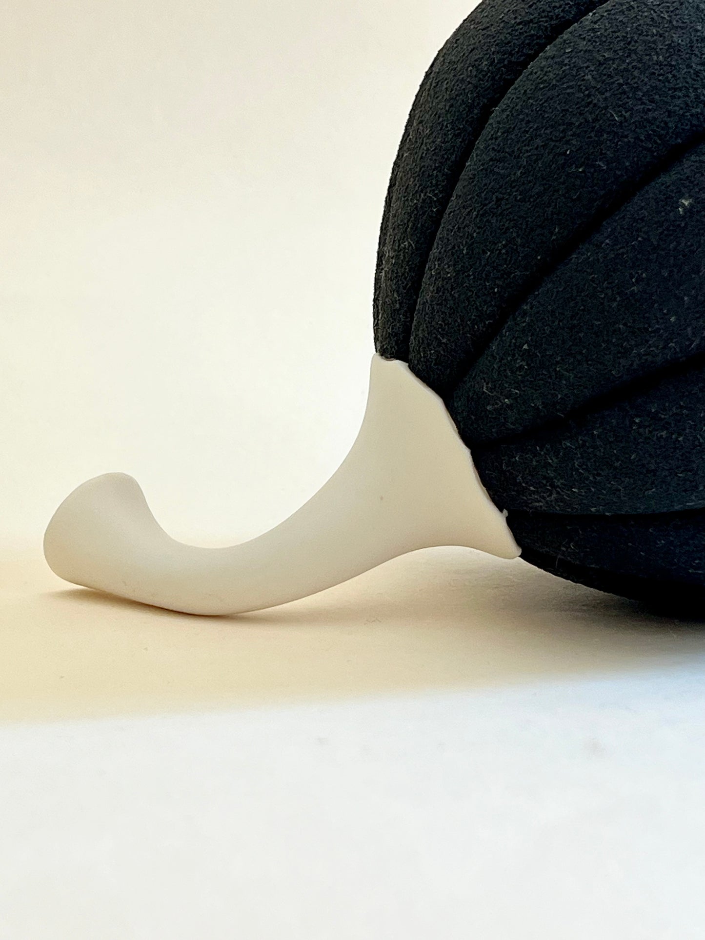 Close-up of textured black porcelain contrasting with smooth white porcelain stem