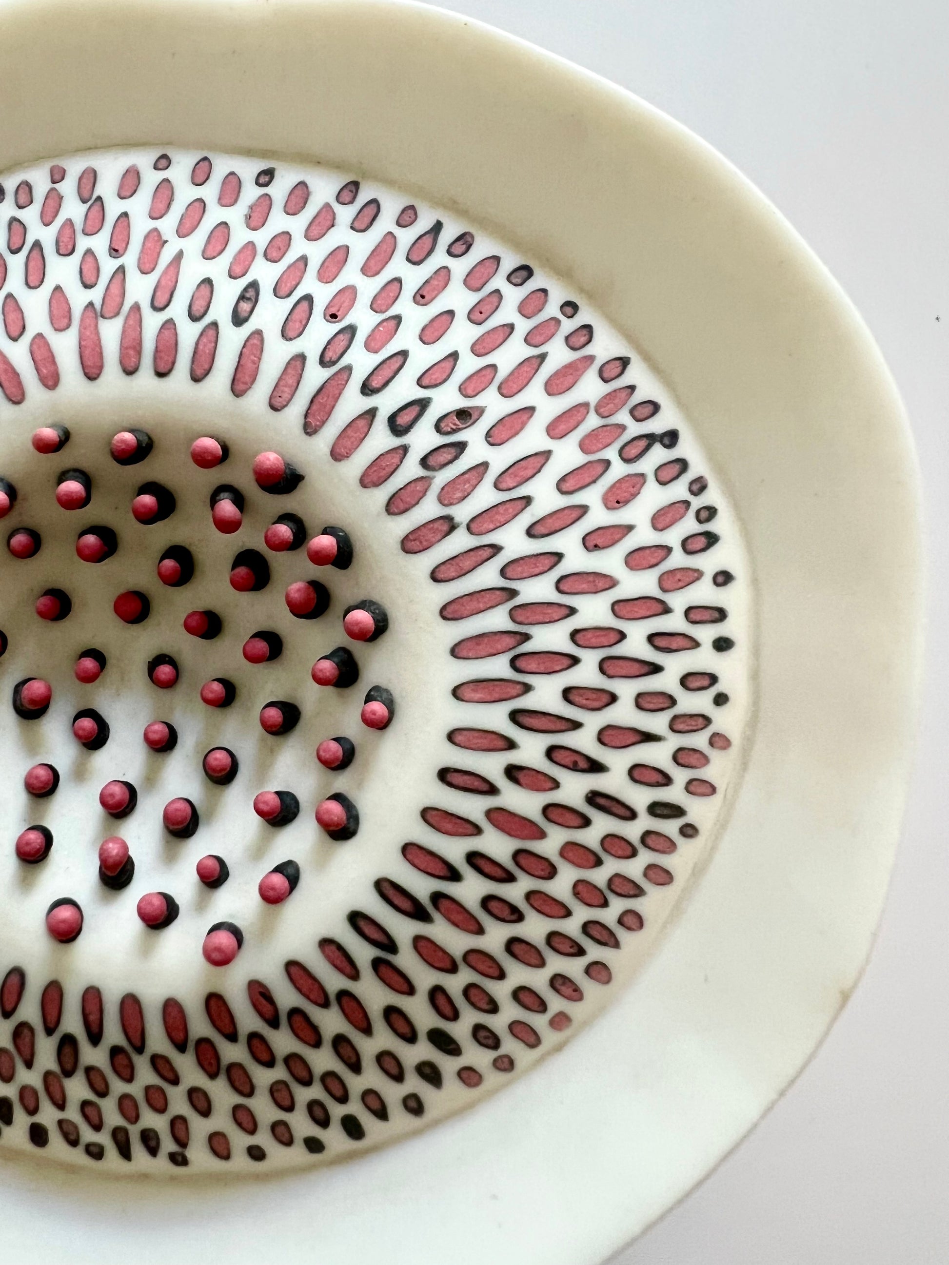Detail of Pulse II showing the red porcelain inlaid pattern and raised red porcelain elements